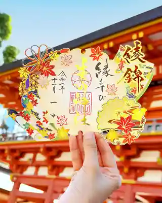 切り絵御朱印【綾錦（あやにしき）】

元々は、美しい絹織物である「綾」と「錦」を重ね合わせた言葉で、転じて、着物などの美しい衣服や、紅葉の鮮やかな色彩を形容する言葉である「綾錦」を切り絵にて配しました。機織りの神様である生田神社の御祭神をイメージし、秋の色鮮やかな紅葉の柄の織物をデザインに取り入れ、切り絵にて表現した御朱印です。（御祭神「稚日女尊」は機殿で神服を織られる神様で、糸と糸とを合わせながら織り成す事から、人と人との御縁を結ぶ神様といわれます）
お受けになった皆様が、美しく色付いていくもみじの様に、彩り豊かな日々をお過ごしになります事をお祈りいたします。
※紅葉の一部を通常のレーザーカットではなく、レーザーの出力を調整し紙を削る技法（ハーフカット）を用い他には無い表現をしております。

授与期間：令和７年１１月１日〜１１月３０日
※状況により無くなる場合もございます。

初穂料：１，０００円
https://ikutajinja.official.ec/items/122663465